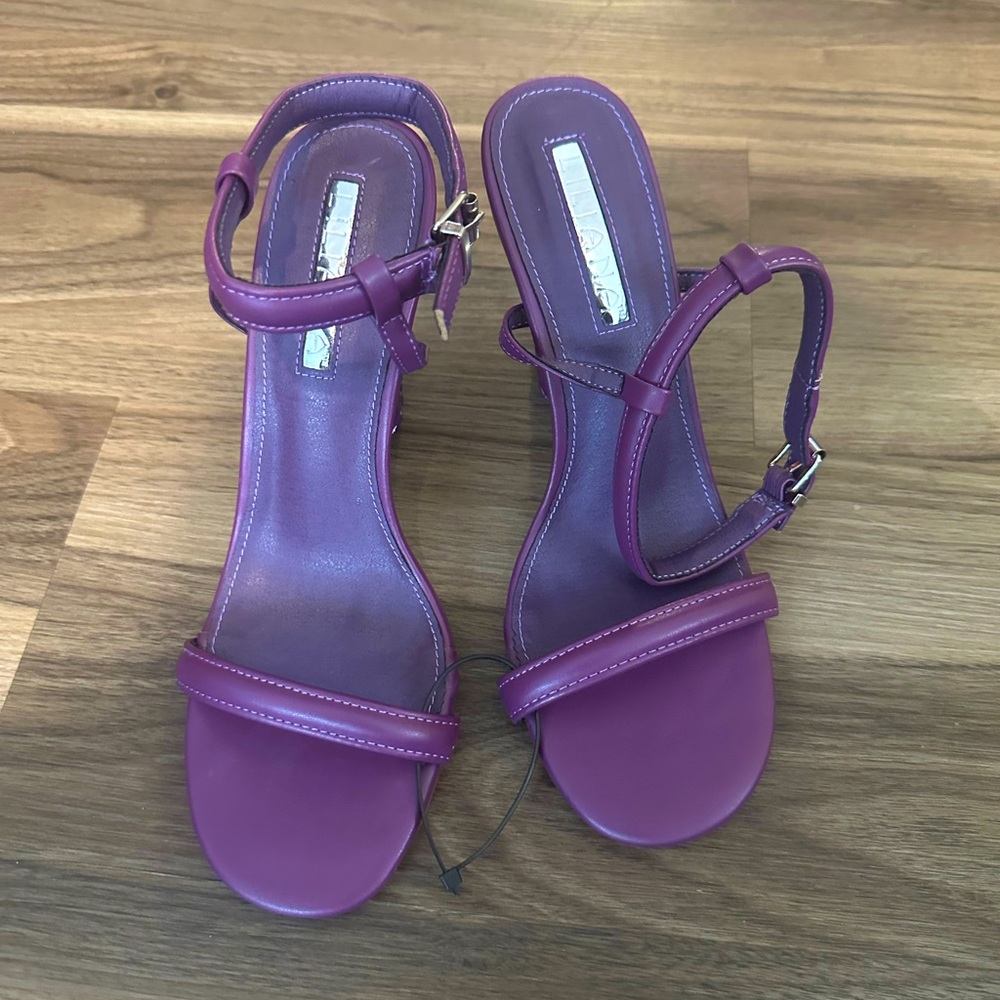 Liliana Purple Heel Sandals. Unique heel measures 3 to 3 1/2 inches